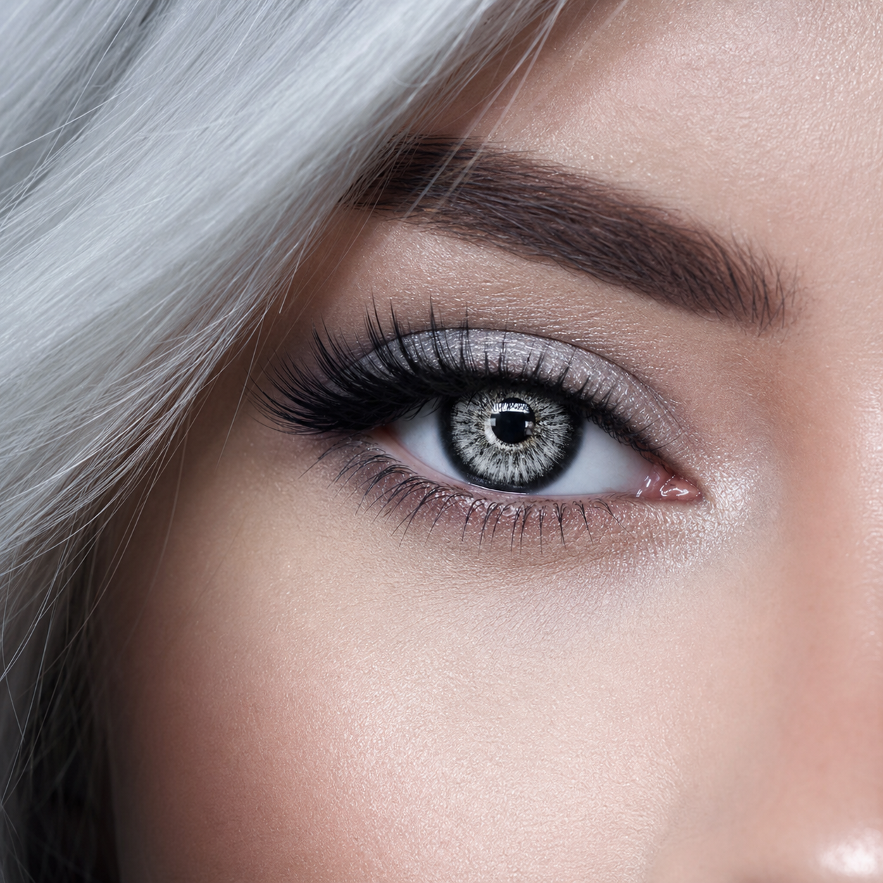 Snowfall Ice Gray colored contacts - a luminous white-gray snowburst center framed by a crisp charcoal edge for instant icy definition